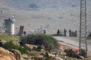 Israeli soldiers stand guard at a checkpoint near the village of Tayasir in the northern West Bank, 4 February